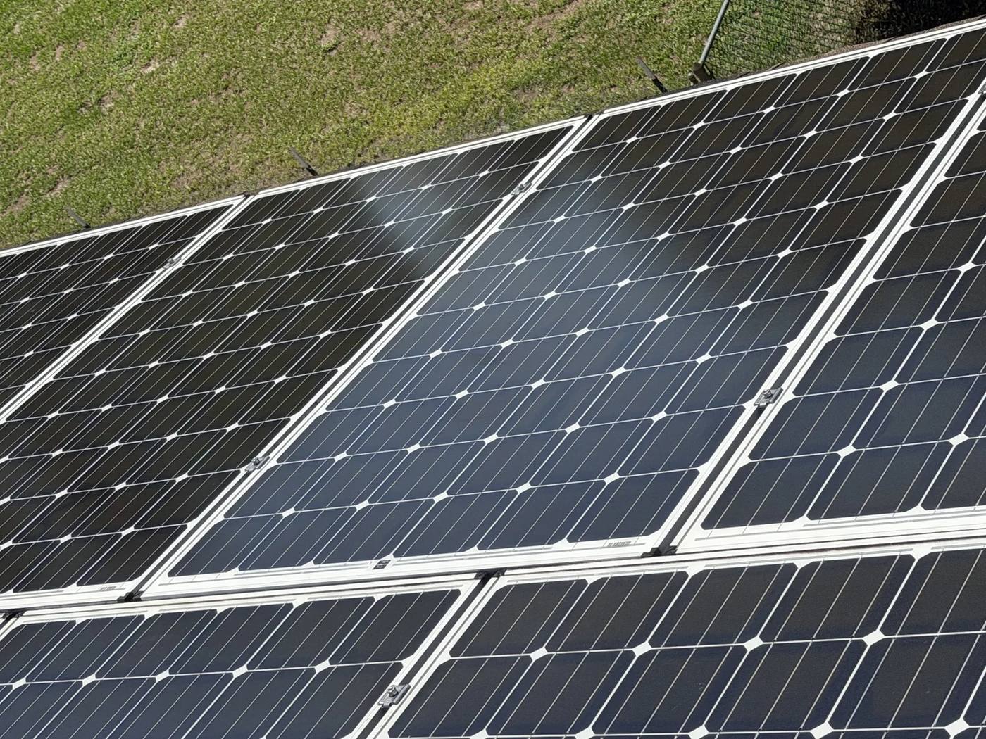Close view of clean solar panels with bright glass and white frames