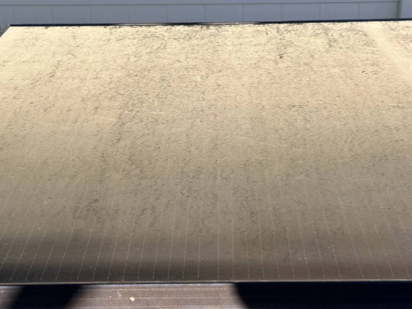 Solar panel covered edge to edge in a thick film of dust and dirt