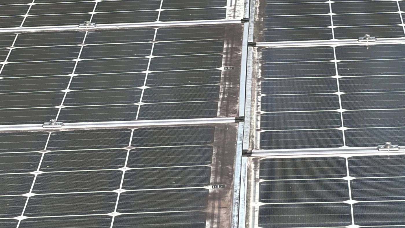 Solar panels with grime built up along the frames and cell lines