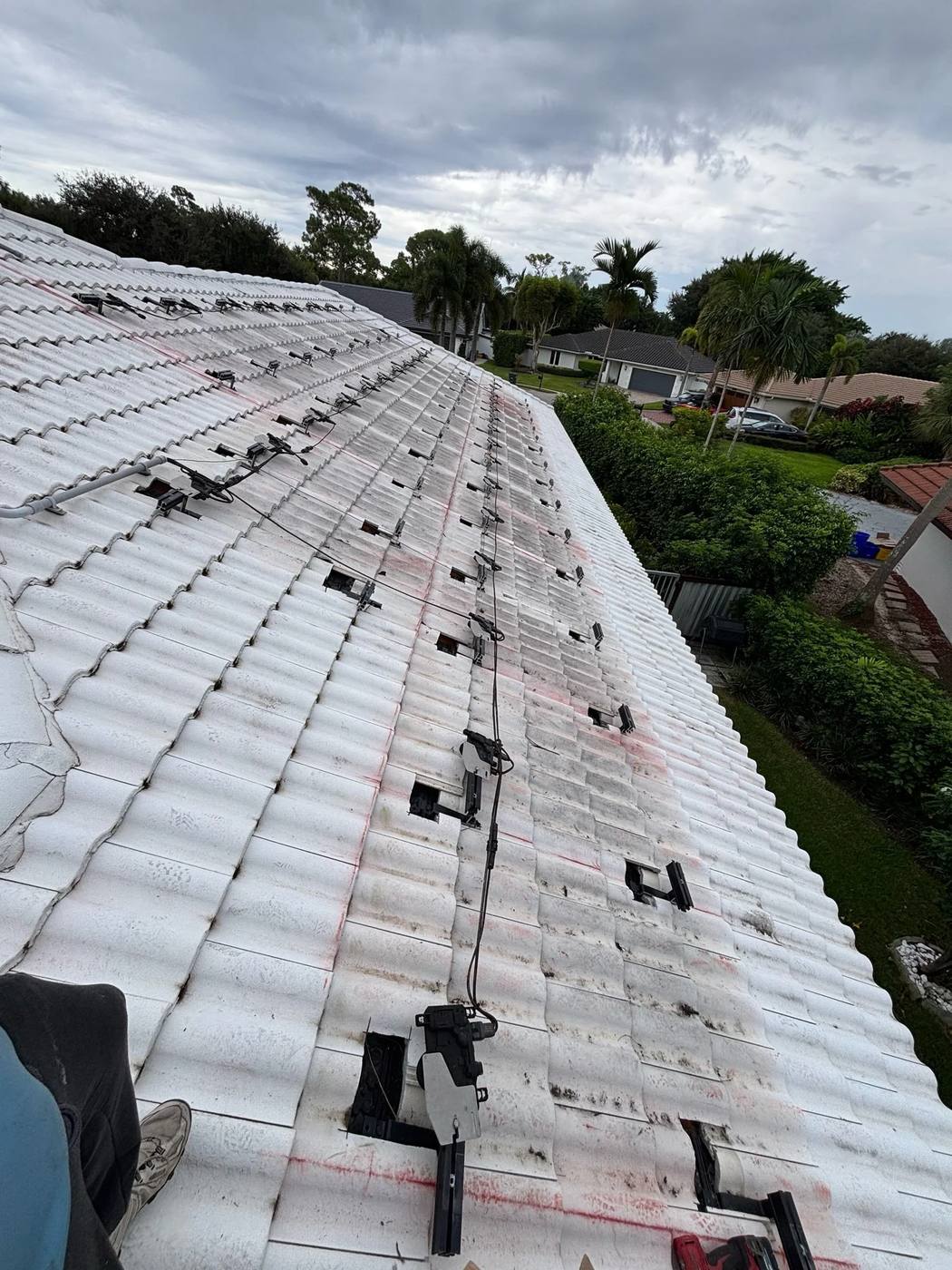 White tile roof with solar mounting feet in place and the panels removed