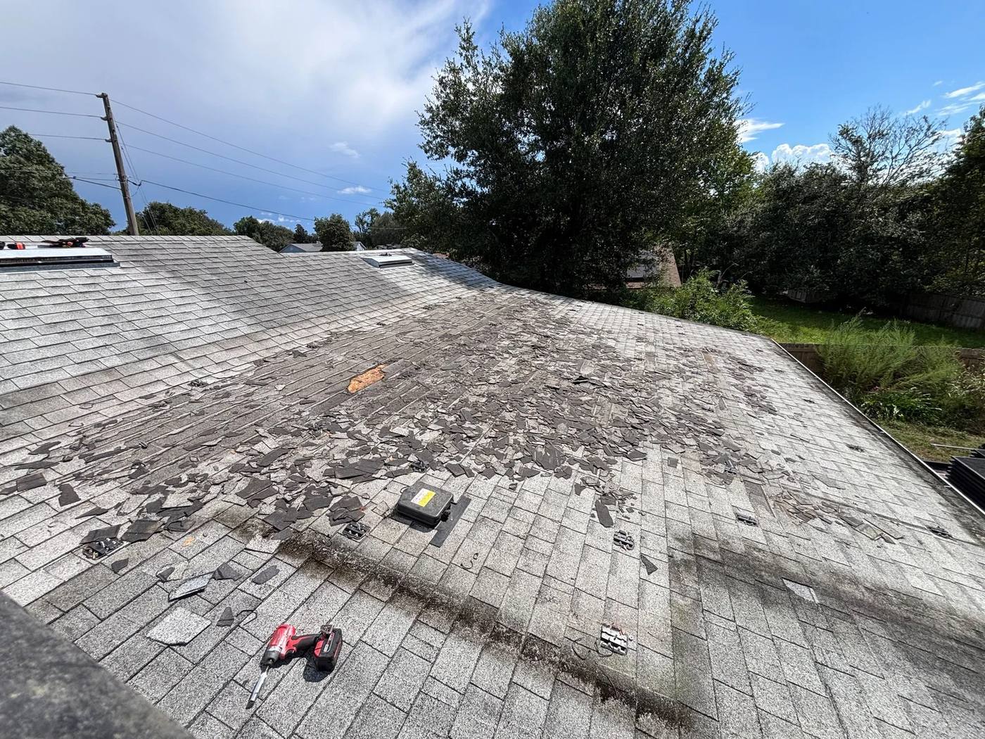 Shingle roof after panel removal, with the dirt outline of where the array sat